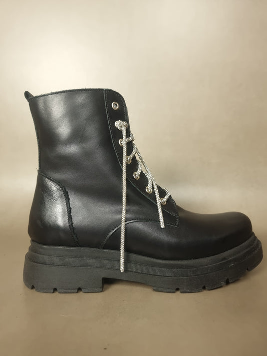 Poorly dyed combat boots with lurex laces